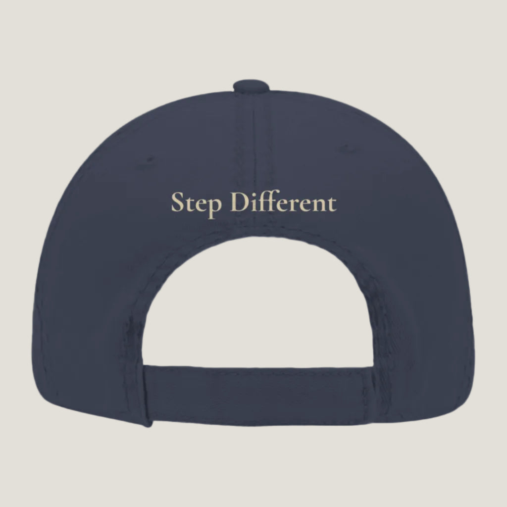 Blue distressed hat with burnt copper “Step Different” embroidery on the back.