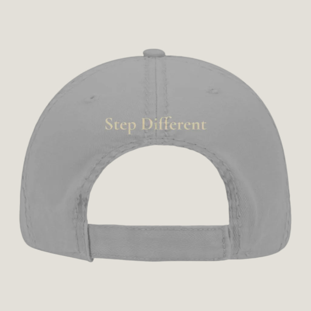Gray distressed hat with burnt copper “Step Different” embroidery on the back.