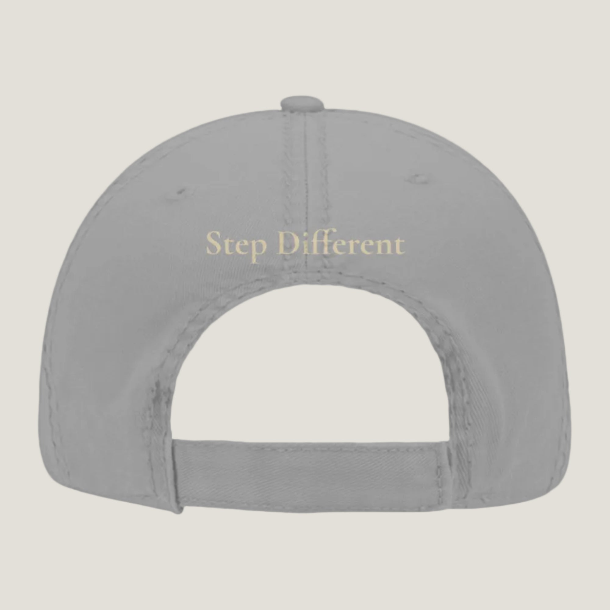 Gray distressed hat with burnt copper “Step Different” embroidery on the back.