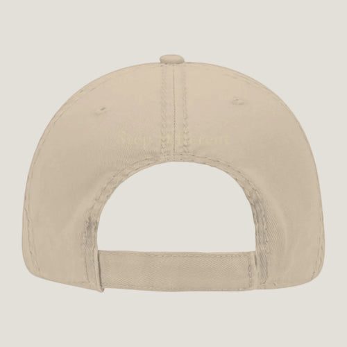 Khaki distressed hat with burnt copper “Step Different” embroidery on the back.