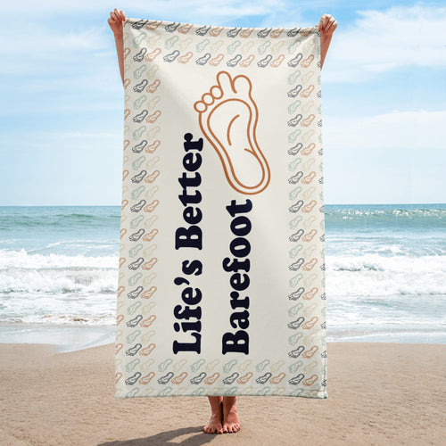Beach Towel with "Life's Better Barefoot" a symbol of a foot with a long toe and a feet boarder.